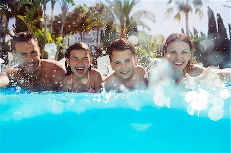 family fun outdoor - Portrait of family with two children in swimming pool Stock Photo - Premium Royalty-Free, Code: 6113-07808096