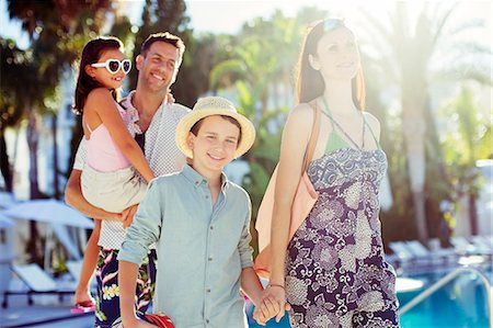 simsearch:6113-07808096,k - Family with two children walking by resort swimming pool Stock Photo - Premium Royalty-Free, Code: 6113-07808135