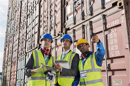 Businessmen and worker talking near cargo containers Fotografie stock - Premium Royalty-Free, Codice: 6113-07808332