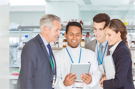 simsearch:6113-07808478,k - Scientist and business people using digital tablet in laboratory Stock Photo - Premium Royalty-Free, Code: 6113-07808491