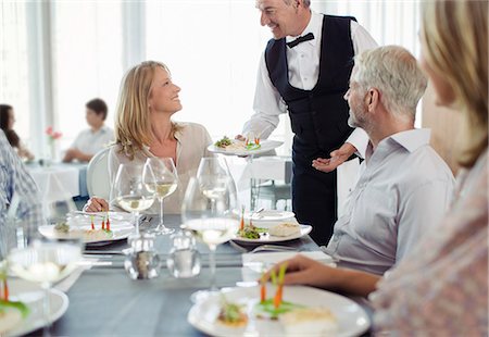 serving (food at restaurant) - Waiter serving fancy dish to woman sitting at restaurant table Stock Photo - Premium Royalty-Free, Code: 6113-07808584