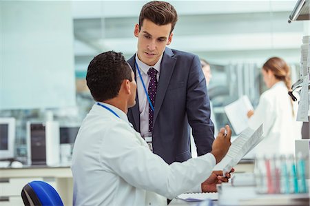 Scientist and businessman talking in laboratory Stock Photo - Premium Royalty-Free, Code: 6113-07808508