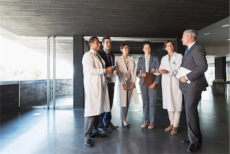 simsearch:6113-07808478,k - Scientists and business people talking in lobby Stock Photo - Premium Royalty-Free, Code: 6113-07808520