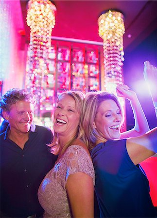 Women and man dancing in nightclub Stock Photo - Premium Royalty-Free, Code: 6113-07808534