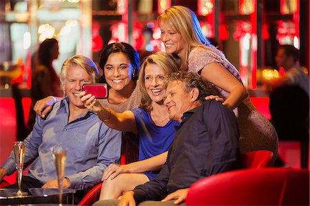 photos of women on cell phones at a party - Group of mature friends taking selfie in nightclub Stock Photo - Premium Royalty-Free, Code: 6113-07808612