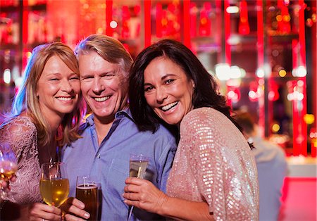 Portrait of smiling mature man and women in nightclub Stock Photo - Premium Royalty-Free, Code: 6113-07808622