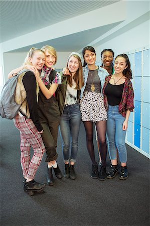 simsearch:6113-07808758,k - Group portrait of cheerful female students standing in locker room Stock Photo - Premium Royalty-Free, Code: 6113-07808756