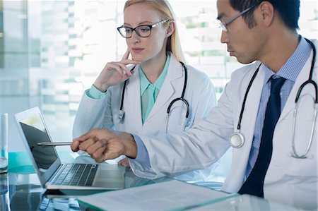 simsearch:6113-07808653,k - Doctors using laptop and discuss patient's treatment Stock Photo - Premium Royalty-Free, Code: 6113-07808704