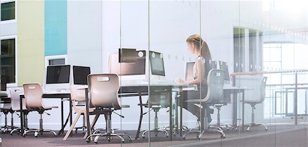 simsearch:6113-07808744,k - Teenage girl using computer in computer room Stock Photo - Premium Royalty-Free, Code: 6113-07808720