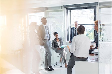 paper material - Smiling business people having meeting in modern in office Photographie de stock - Premium Libres de Droits, Code: 6113-07808843