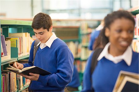 school window - Female and male teenage students holding books in school library Stock Photo - Premium Royalty-Free, Code: 6113-07961396