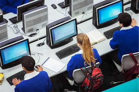 Elevated view of students sitting and learning in computer room Stock Photo - Premium Royalty-Free, Code: 6113-07961454