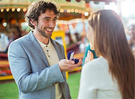 Man proposing to girlfriend in amusement park Stock Photo - Premium Royalty-Free, Code: 6113-07961579
