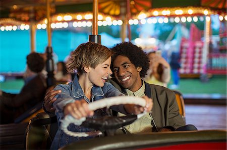 Young couple on bumper car ride in amusement park Stock Photo - Premium Royalty-Free, Code: 6113-07961581