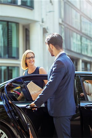 Chauffeur opening car door for businesswoman Stock Photo - Premium Royalty-Free, Code: 6113-07961649