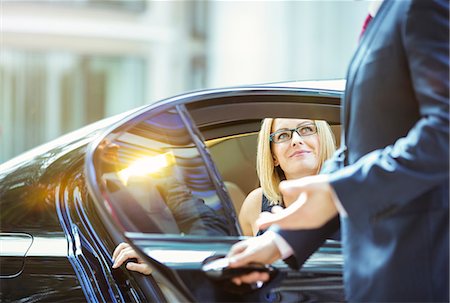 people smiling close ups - Chauffeur opening car door for businesswoman Stock Photo - Premium Royalty-Free, Code: 6113-07961659