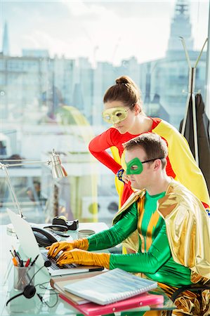 simsearch:6113-07961683,k - Superheroes working on laptop in office Stock Photo - Premium Royalty-Free, Code: 6113-07961695