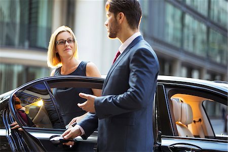 people sitting in car - Chauffeur opening car door for businesswoman Stock Photo - Premium Royalty-Free, Code: 6113-07961628