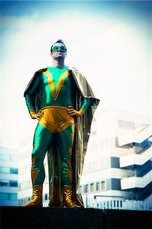 serious city - Superhero standing near city skyline Stock Photo - Premium Royalty-Free, Code: 6113-07961701