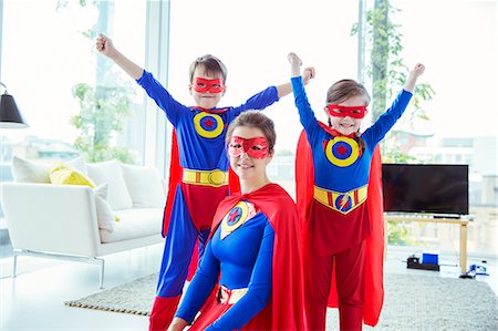 simsearch:6122-07700668,k - Superhero children and mother smiling in living room Stock Photo - Premium Royalty-Free, Code: 6113-07961724