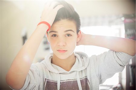 Portrait of teenage boy with hand in hair Photographie de stock - Premium Libres de Droits, Code: 6113-07991949