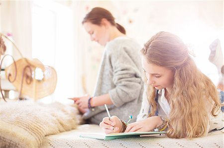 simsearch:6113-07991958,k - Two teenage girls on bed writting in notepads Stockbilder - Premium RF Lizenzfrei, Bildnummer: 6113-07991952