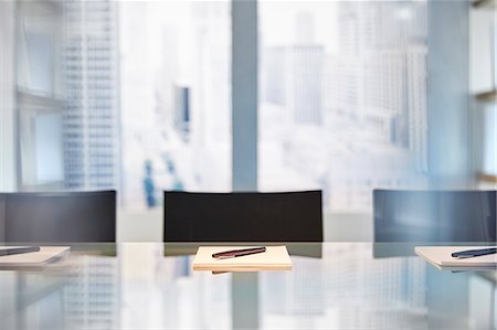 empty interior - Part of modern conference room with table chairs, notepads and pens Stock Photo - Premium Royalty-Free, Code: 6113-07991911