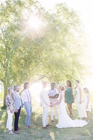 south africa and african people and happy - Young couple and guests during wedding ceremony in domestic garden Stock Photo - Premium Royalty-Free, Code: 6113-07992181