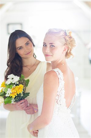 simsearch:6113-07992159,k - Portrait of bride and bridesmaid with bouquet of flowers in domestic room Fotografie stock - Premium Royalty-Free, Codice: 6113-07992184