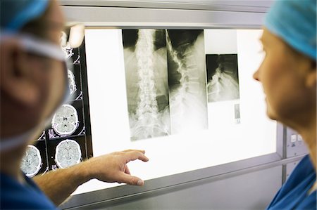 Two mature doctors discussing patient's x-ray and MRI scans Stock Photo - Premium Royalty-Free, Code: 6113-07905815