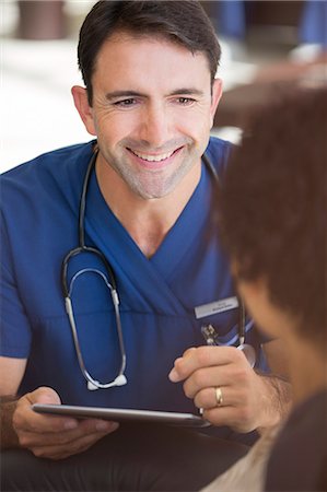 simsearch:6113-07905909,k - Portrait of smiling mid adult doctor holding tablet pc Stock Photo - Premium Royalty-Free, Code: 6113-07905831