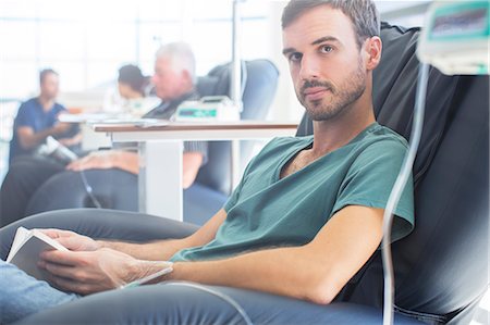 patients with iv - Portrait of young patient getting treatment and holding book Stock Photo - Premium Royalty-Free, Code: 6113-07905832