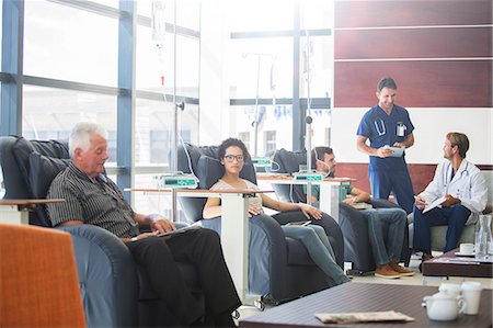 seniors at table - Patients undergoing medical treatment with doctors discussing in outpatient clinic Stock Photo - Premium Royalty-Free, Code: 6113-07905950