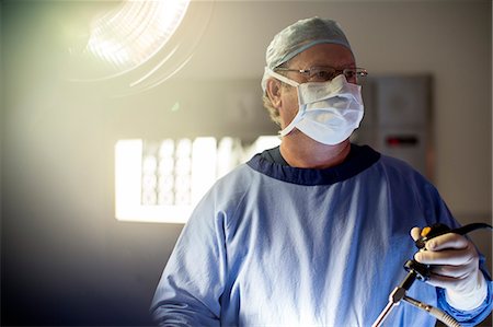 Surgeon performing laparoscopic surgery in operating theater Stock Photo - Premium Royalty-Free, Code: 6113-07905961