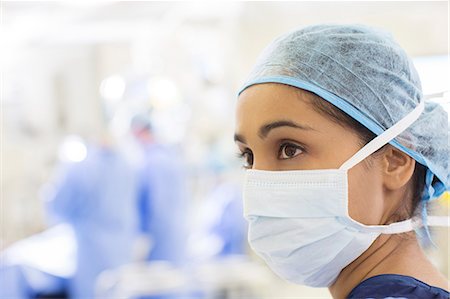 simsearch:6113-07905835,k - Portrait of surgical nurse wearing surgical cap and mask in operating theater Foto de stock - Sin royalties Premium, Código: 6113-07905968