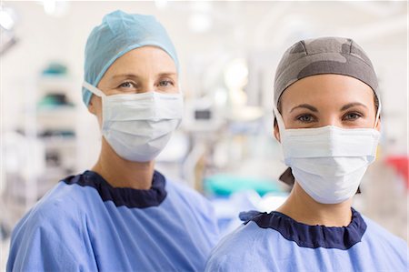 simsearch:6113-07905909,k - Portrait of female doctors wearing scrubs in operating theater Stock Photo - Premium Royalty-Free, Code: 6113-07905907