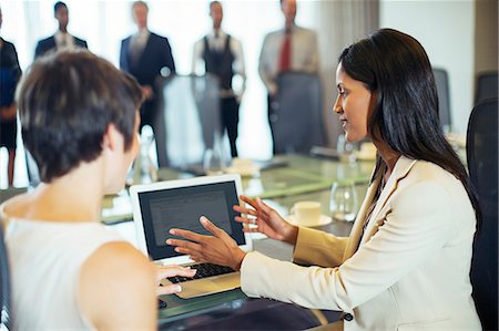 Businesswomen sitting with tablet pc in conference room Stock Photo - Premium Royalty-Free, Code: 6113-07906051