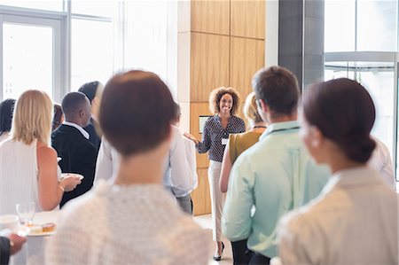 professional direction - Business people standing in office hall holding trays with cakes and drinking water Stock Photo - Premium Royalty-Free, Code: 6113-07906067