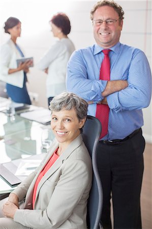 simsearch:632-05604308,k - Two mature business people looking at camera, smiling in conference room Stock Photo - Premium Royalty-Free, Code: 6113-07906077