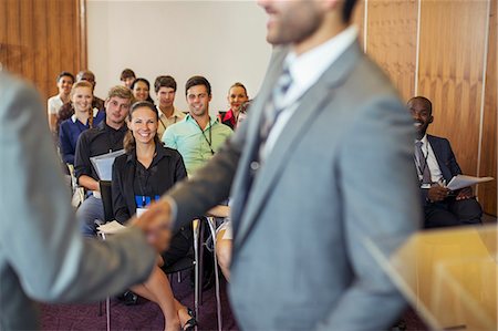 pulpit - Two businessmen shaking hands during conference in conference room Stock Photo - Premium Royalty-Free, Code: 6113-07906082