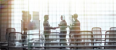 simsearch:6113-07762466,k - Business people standing in conference room shaking hands Stock Photo - Premium Royalty-Free, Code: 6113-07906001