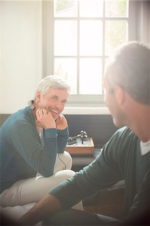 simsearch:6113-07906200,k - Men relaxing together in living room Stock Photo - Premium Royalty-Free, Code: 6113-07906154