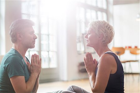 Older couple meditating Stock Photo - Premium Royalty-Free, Code: 6113-07906178