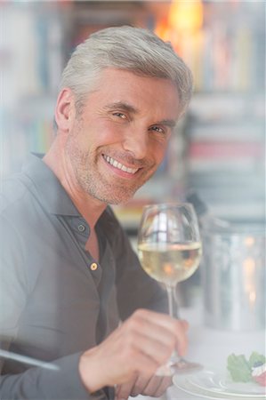 simsearch:6113-07906200,k - Older man drinking white wine at dinner Stock Photo - Premium Royalty-Free, Code: 6113-07906187