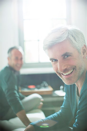 Gay couple relaxing together with record player Stock Photo - Premium Royalty-Free, Image code: 6113-07906188