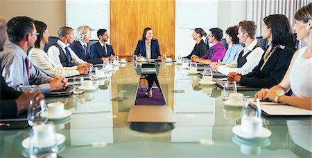 saucer - Conference participants looking at young woman sitting at head of conference table Stock Photo - Premium Royalty-Free, Code: 6113-07906100