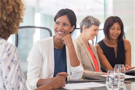 simsearch:6113-07906049,k - Four women sitting and talking at conference table Photographie de stock - Premium Libres de Droits, Code: 6113-07906123