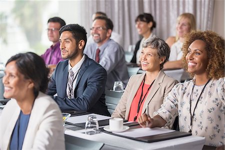 Group of people sitting and listening to speech during seminar Stock Photo - Premium Royalty-Free, Code: 6113-07906134