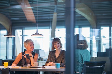 people at creative office - Businesswomen talking in office meeting Stock Photo - Premium Royalty-Free, Code: 6113-07906247