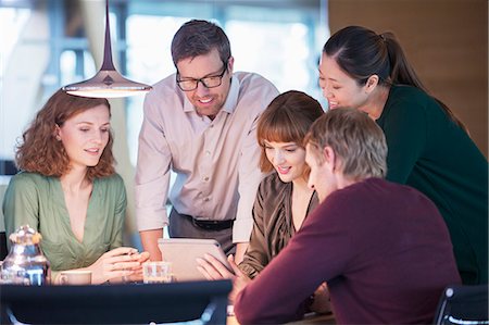 Business people using digital tablet in office meeting Stock Photo - Premium Royalty-Free, Code: 6113-07906285